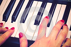 Close up of Keybord of synthesizer and woman hands