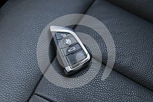 Close up of keys of BMW XM 201 in black leather perforated seat car interior. Car interior details. Car detailing