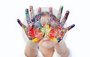 Close up kid hands painted in colorful paints isolated over white background