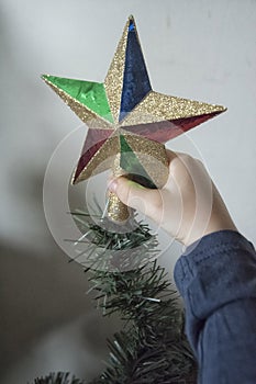 A close-up of kids hands with a Christmas ornament