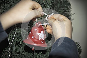 A close-up of kids hands with a Christmas ornament