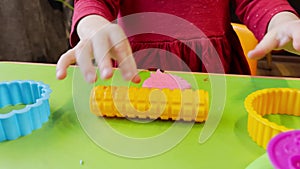 Close up of kids hands molding colorful childs play clay. Learning educational activities for children at home, in