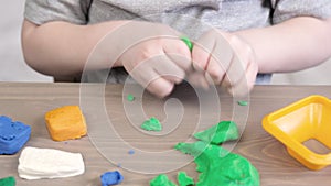 Close up of kids hands molding colorful childs play clay. Learning educational activities for children at home, in kindergarten.