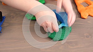 Close up of kids hands molding colorful childs play clay. Learning educational activities for children at home, in kindergarten. C