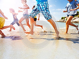 Close up of kids legs running on the beach