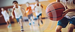 Close-up of kids playing basketball at school gym