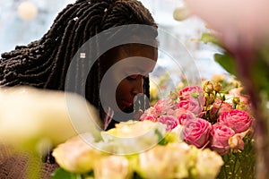 Close up of kind woman that smelling roses