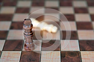 Close-up king chess stand on falling chess concepts of competition challenge of leader business team or teamwork volunteer or
