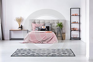 Pastel pink cozy bedroom with grey and black accents photo