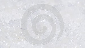 Close-up of kitchen iodized salt rotating on a plate. Crystal white salt video background