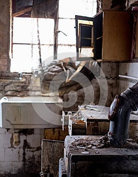 Close up of kitchen left in appalling condition in derelict 1930s deco house. Rayners Lane, Harrow UK photo