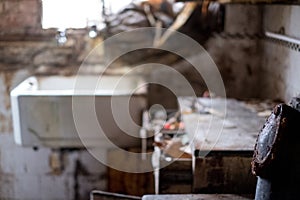 Close up of kitchen left in appalling condition in derelict 1930s deco house. Rayners Lane, Harrow UK photo