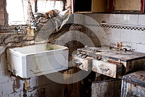 Close up of kitchen left in appalling condition in derelict 1930s deco house. Rayners Lane, Harrow UK photo