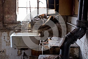 Close up of kitchen left in appalling condition in derelict 1930s deco house. Rayners Lane, Harrow UK photo