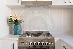 Close up of kitchen oven and tiled splashback