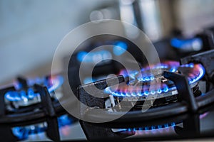 Close-up kitchen stove cook with blue flames burning