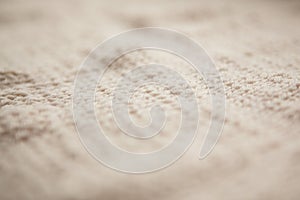 Close up of knitting beige textured wool background, old style