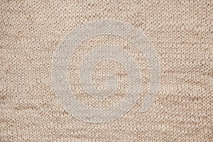 Close up of knitting beige textured wool background, vintage old style