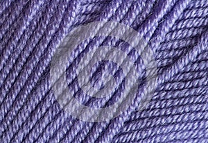 Close-up, knitting texture. The violet thread and knitting.