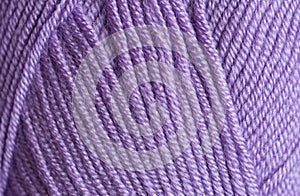 Close-up, knitting texture. The violet thread and knitting.