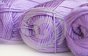 Close-up, knitting texture. The violet thread and knitting.