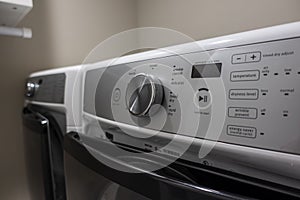 Close up of a knob and button panel on a high end, energy efficient clothing dryer