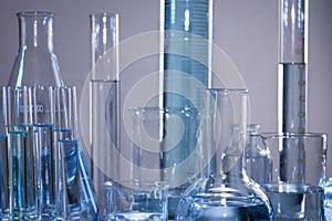 Close up of labware such as beaker, flask, graduated cylinders and test tubes well placed