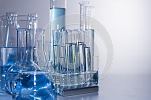 Close up of labware such as beaker, flask, graduated cylinders and test tubes well placed