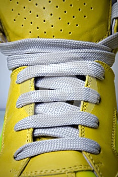 Close-up laces on the yellow boots