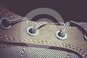 Close up lacing of a brown suede leather adventure boot