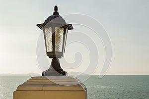 Close up lamp post and sea