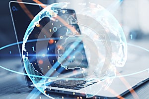 Close up of laptop with abstract globe sphere with coding and polygonal network on blurry background. Future, technology and