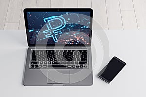 Close up of laptop and cellphone on desktop with digital ruble icon on background. Trade, finance and money concept. 3D