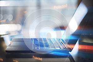Close up of laptop computer with abstract binary code on blurry background. Cyber attack and hacking concept.