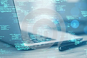 Close up of laptop computer on desk with supplies and creative coding html language on blurry background. Web developer and