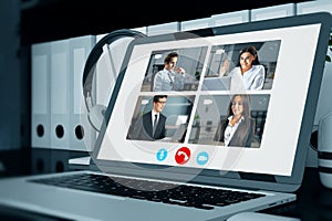 Close up of laptop computer with video conference call on screen. Work, home and remote team concept