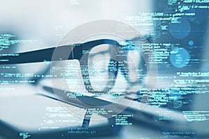 Close up of laptop on desk with glasses, smartphone and creative coding html language on blurry background. Web developer and