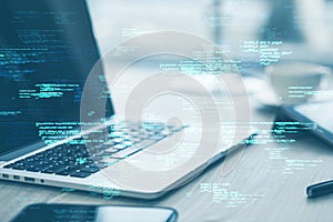 Close up of laptop on desk with supplies and creative coding html language on blurry background. Web developer and programming