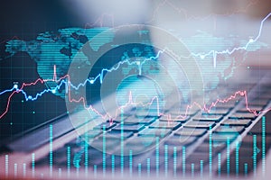 Close up of laptop on desktop with abstract forex chart and map. Fintech, trade and data exchange concept.