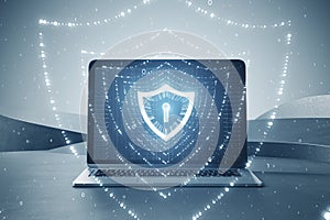 Close up of laptop with glowing polygonal web security shield hologram on blurry abstract background. Digital interface and