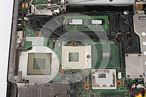 Close up of  laptop processor  with empty socket base for CPU and integrated graphics card on main board of notebook