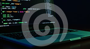 Close Up of Laptop Screen Displaying Programming Code in Dark Environment