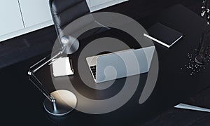 Close up of laptop, lamp and notepad on the table, 3d rendering.