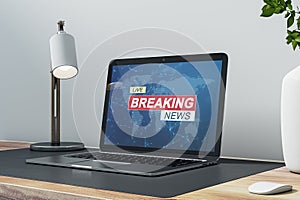 Close up of laptop at workplace with different objects and creative polygonal breaking news and globe hologram. Television, online