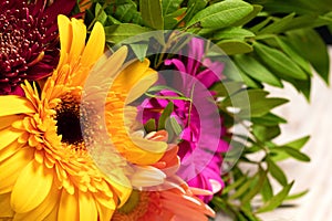 Close-up of large beautiful orange gerbera flower in colorful bouquet of flowers.