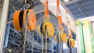 Close-up of large hanging industrial hooks with chains.