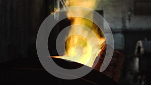 Close-up of large iron melting furnace with yellow-green flame in the top on the old metallurgic factory or plant. Stock