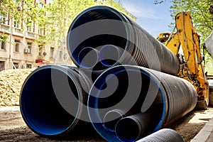 Close-up a large plastic corrugated pipes for water supply lie on the street in the city