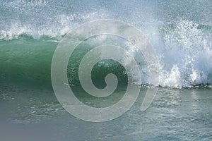 Close up of large wave crashing in the ocean