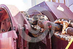 Close-up of a large windlass winch on the bow of a cargo ship